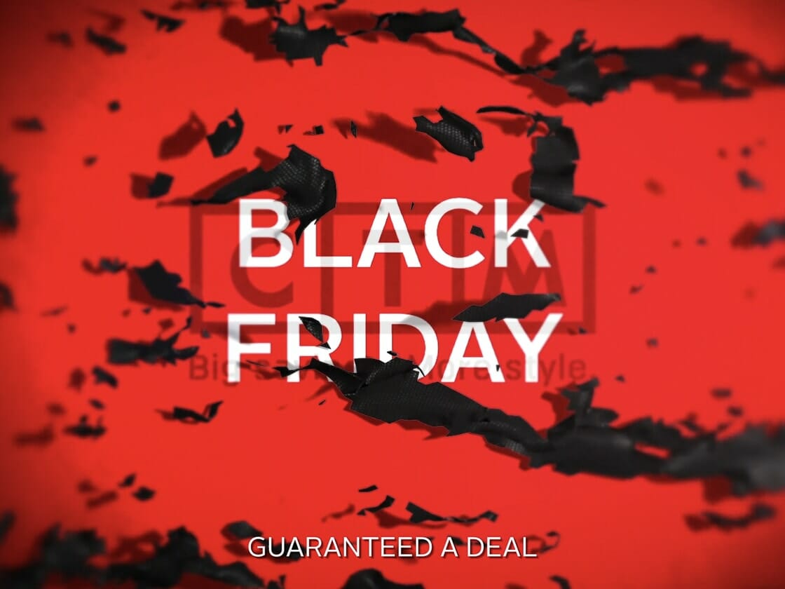 An abstract red and black design with scattered black fragments on a red background. Bold white uppercase text in the center reads "BLACK FRIDAY." Smaller white text at the bottom says "GUARANTEED A DEAL." The letters C, T, M are faintly visible behind the "BLACK FRIDAY" promo text.