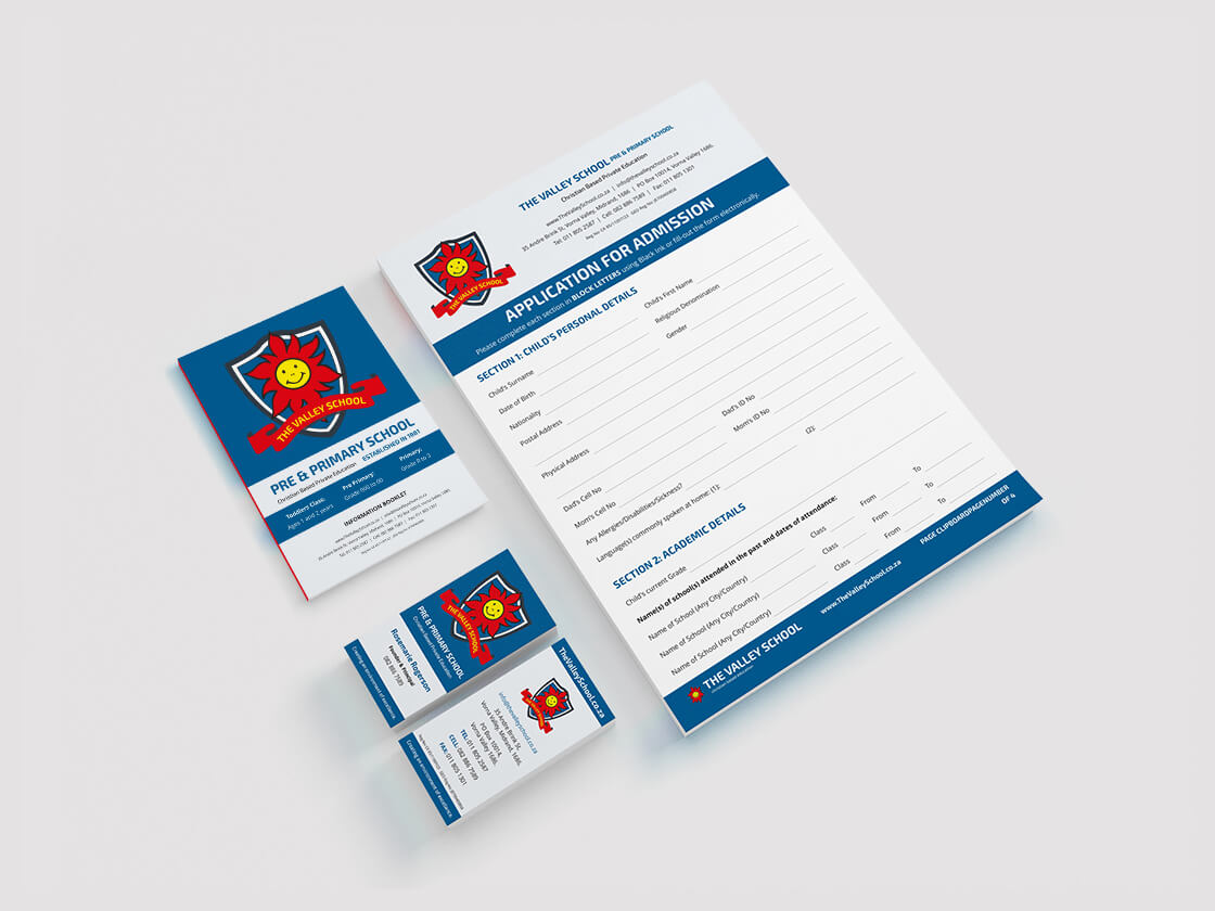 Project The Valley School stationery A set of school stationery on a white surface, including an application form, brochure, and two business cards. All items are designed in blue, red, and white with a yellow sun logo and text for “Pine Valley School” visible on each piece.